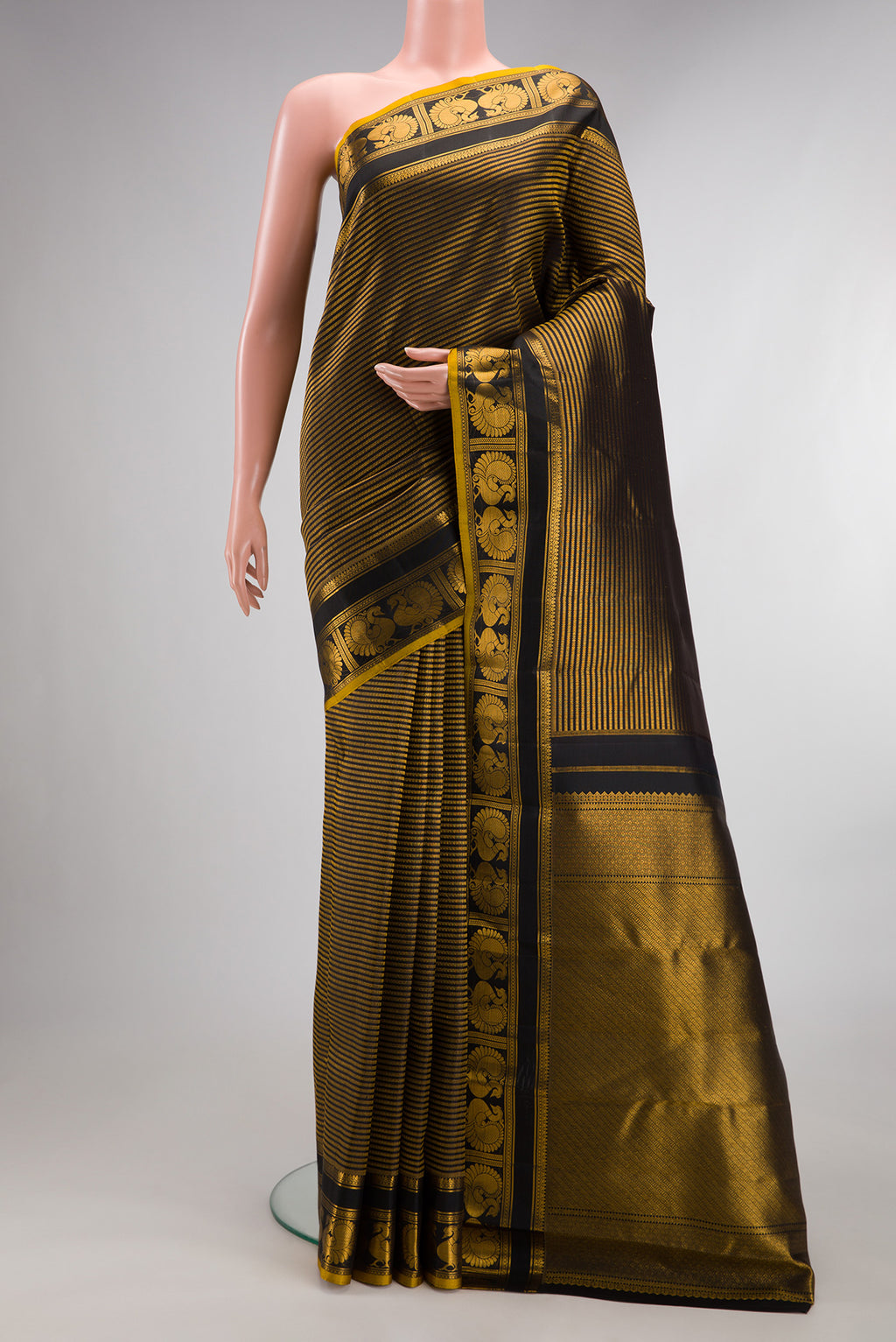 Pure Silk Black Dual Tone Kanchipuram Saree with Stripes on the body and Fancy Border.  displayed on a mannequin