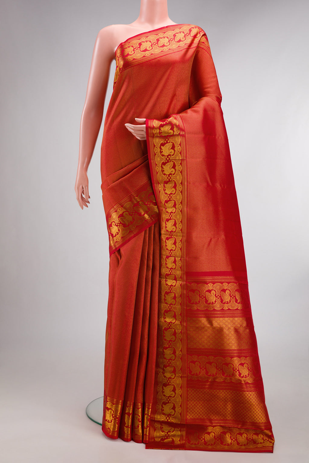 Pure Silk Red Dual Tone Kanchipuram Saree with Zari Brocade on the body and Fancy Border.  displayed on a mannequin