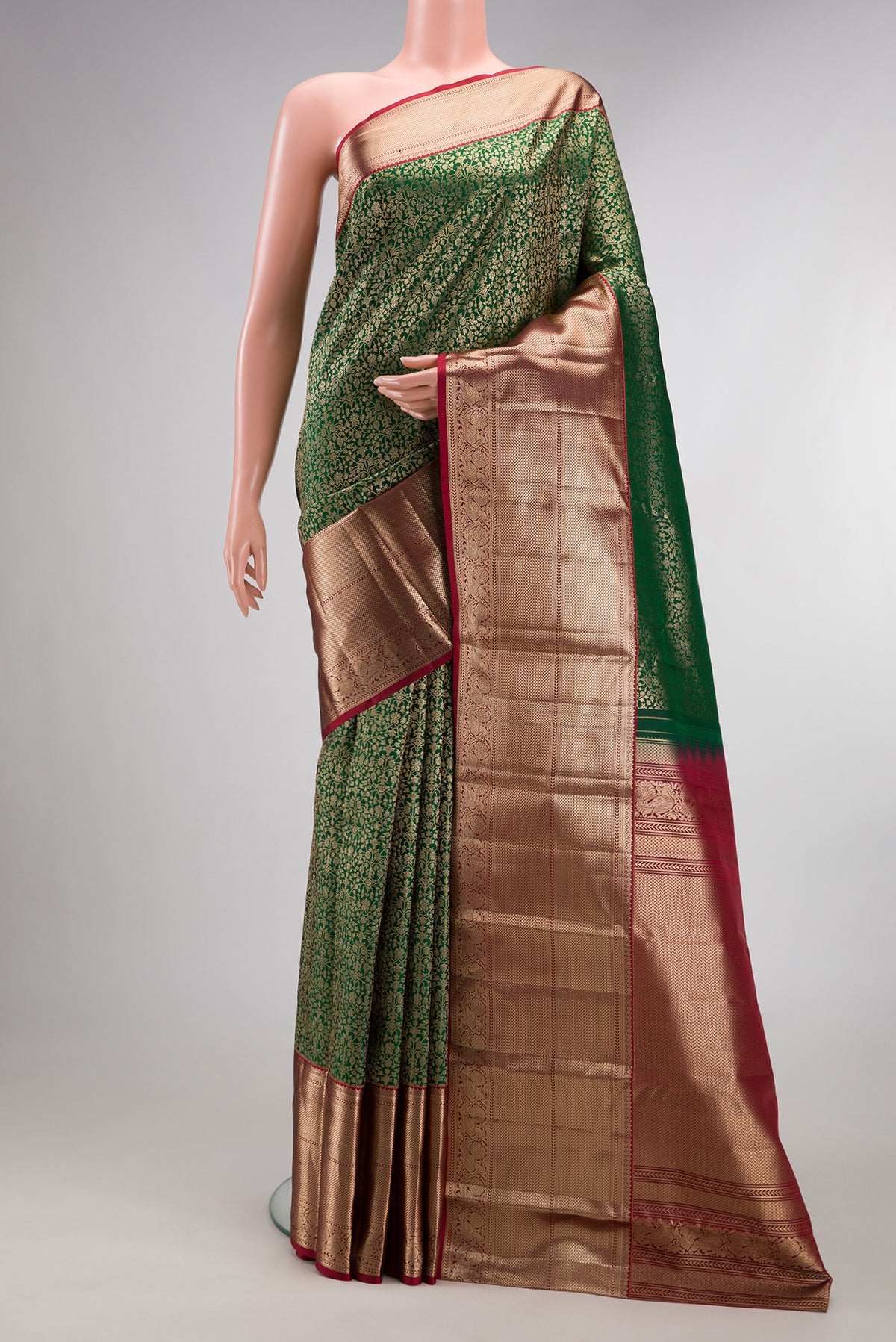 Pure Silk Bottle Green Kanchipuram Saree with Zari Brocade on the body and Zari Border.  displayed on a mannequin