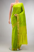 Pure Silk Parrot Green Soft Saree with Zari Butta on the body and Zari Border.  displayed on a mannequin