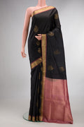 Pure Silk Black Soft Saree with Zari Butta on the body and Zari Border.  displayed on a mannequin