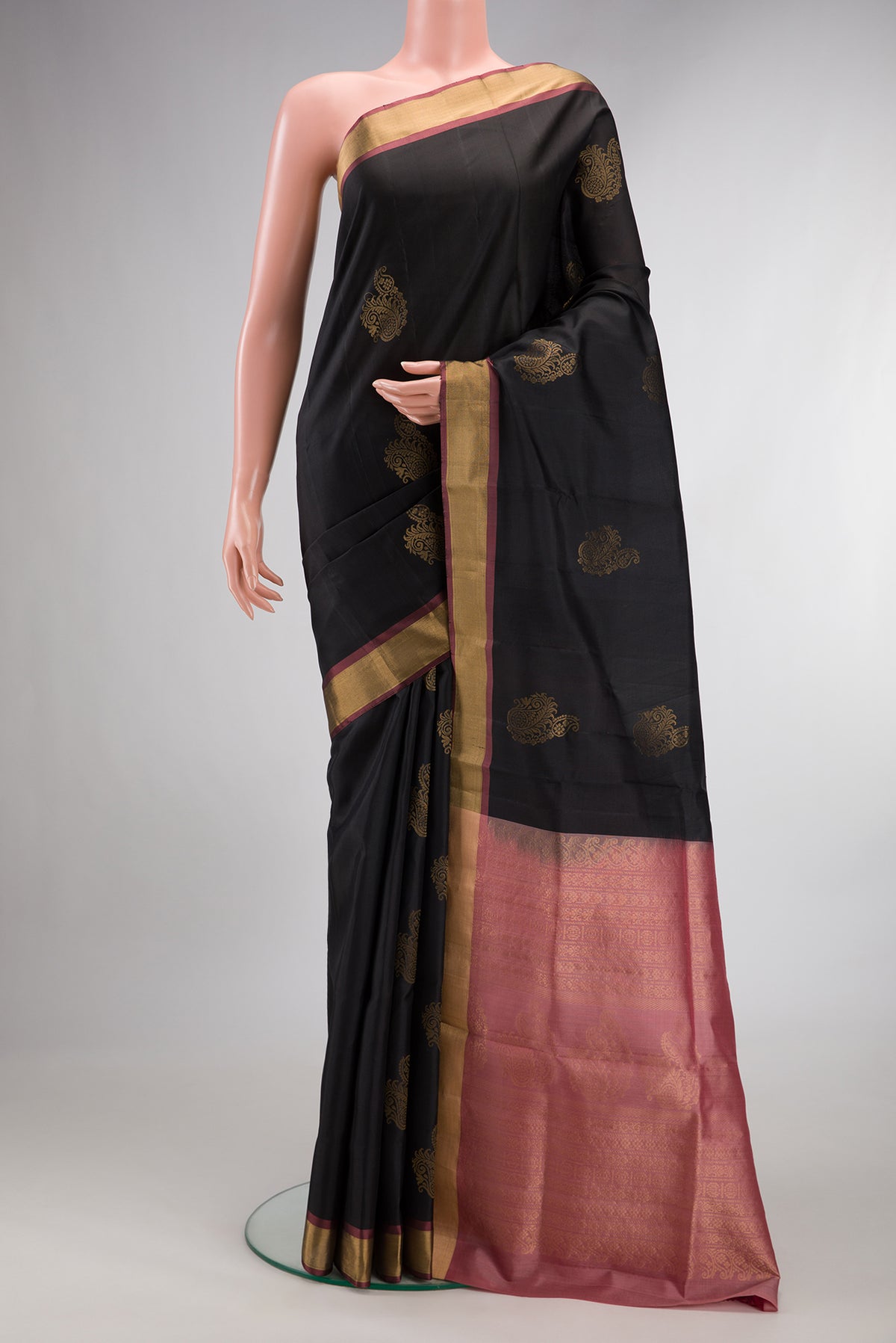 Pure Silk Black Soft Saree with Zari Butta on the body and Zari Border.  displayed on a mannequin