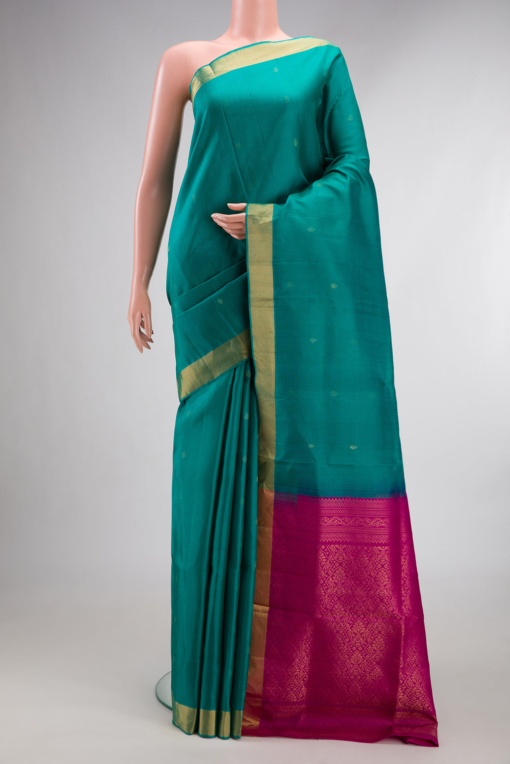 Pure Silk Sea Green Soft Saree with Zari Butta on the body and Zari Border.  displayed on a mannequin