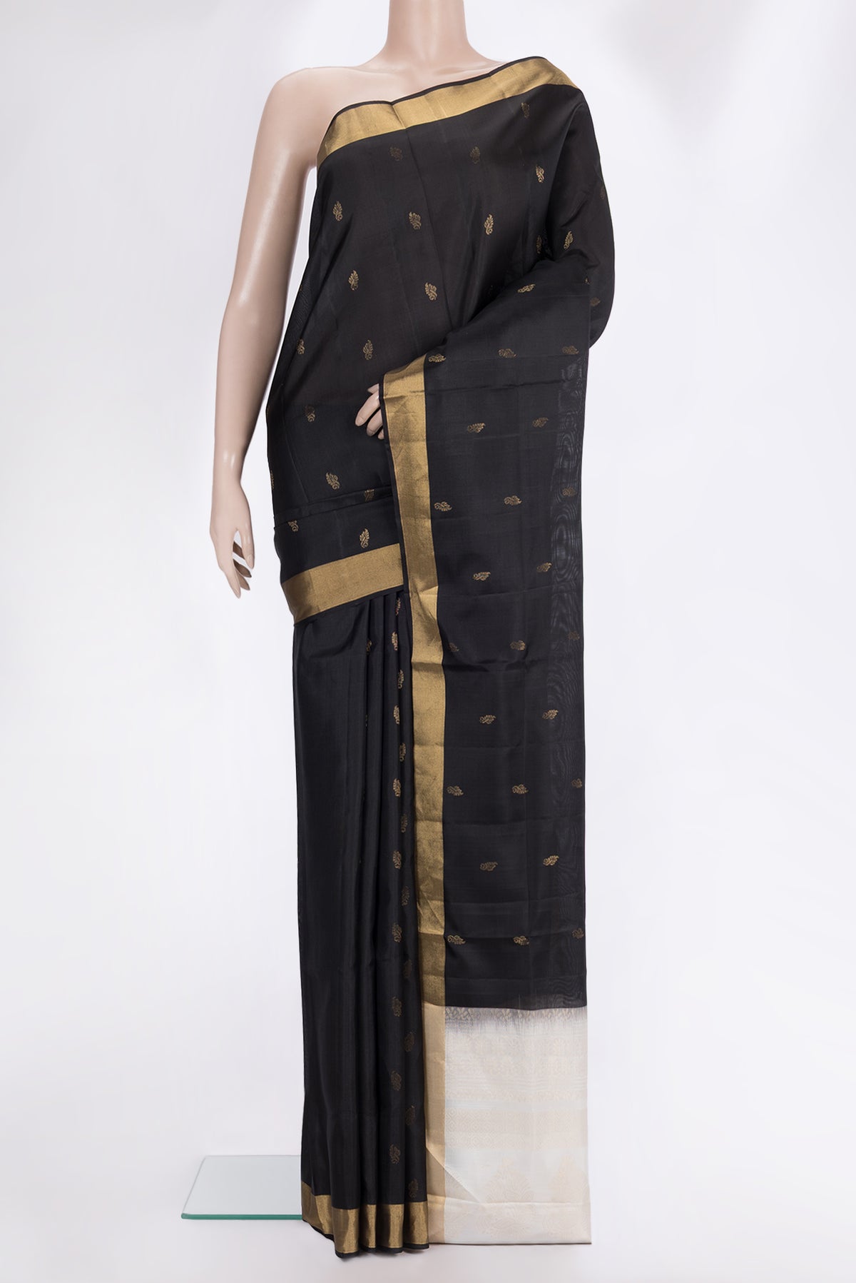 Pure Silk Black Soft Saree with Zari Butta on the body and Zari Border.  displayed on a mannequin