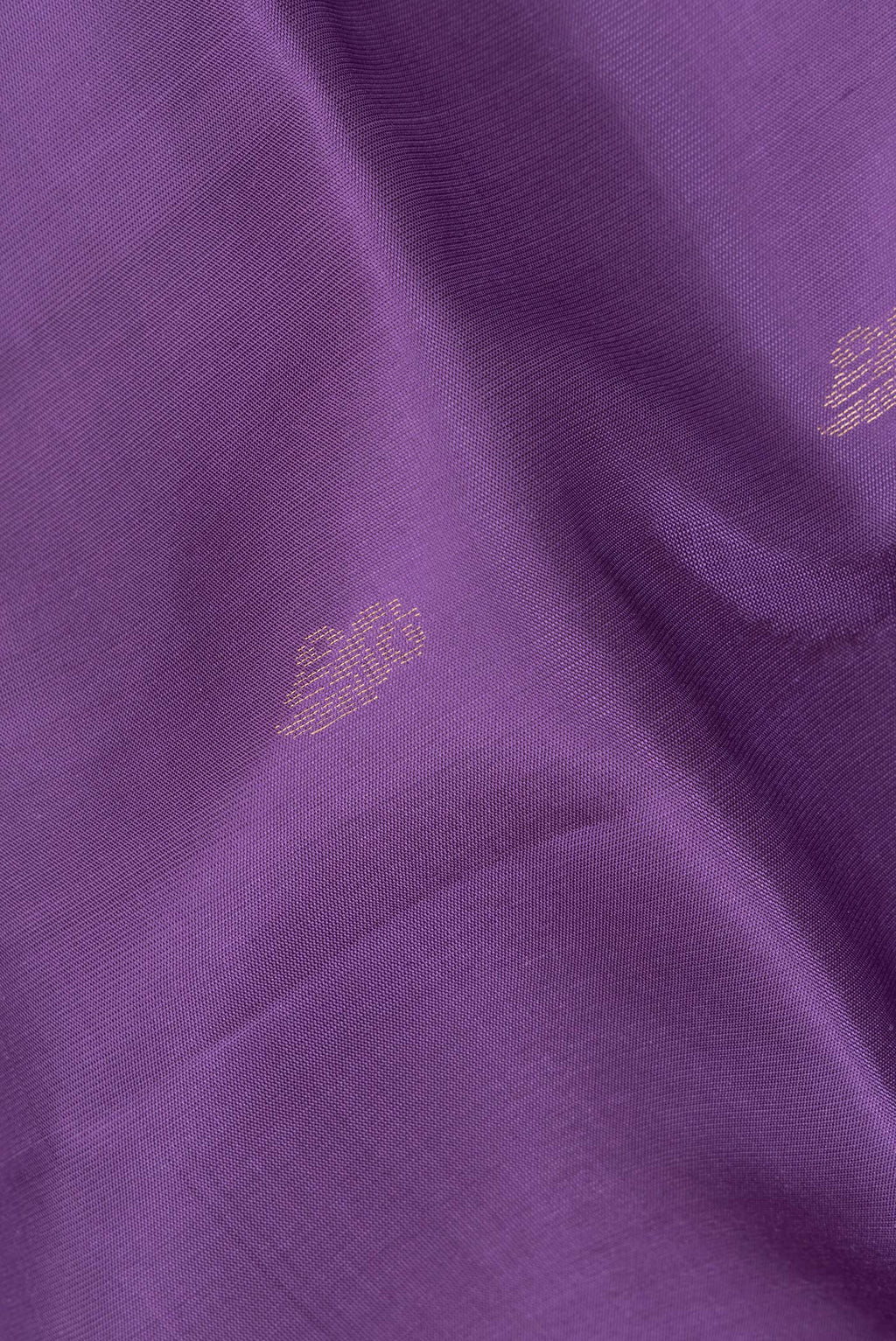 Close up of Pure Silk Lavender Soft Saree with Zari Butta on the body and Zari Border.  displaying folds