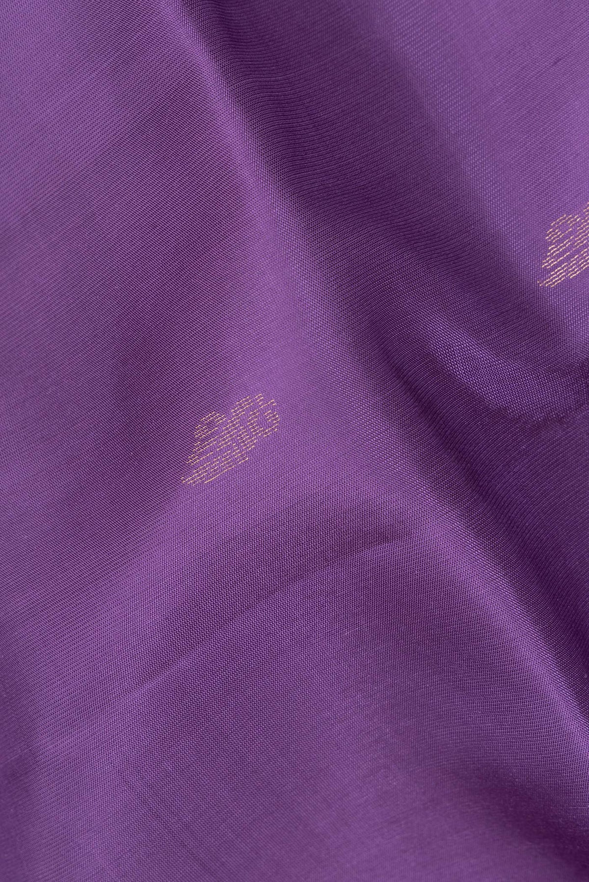 Close up of Pure Silk Lavender Soft Saree with Zari Butta on the body and Zari Border.  displaying folds