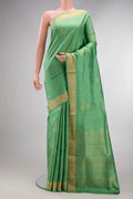 Pure Silk Light Green Soft Saree with Zari Butta on the body and Zari Border.  displayed on a mannequin