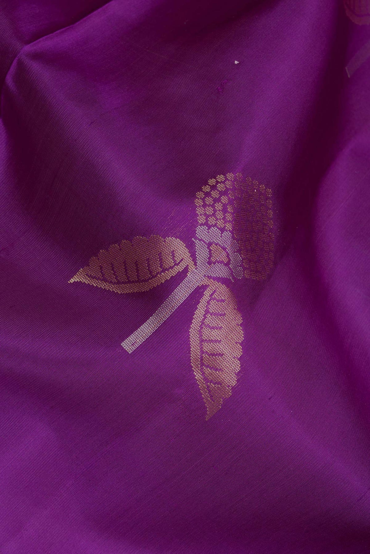Close up of Pure Silk Purple Soft Saree with Zari Butta on the body and Zari Border.  displaying folds