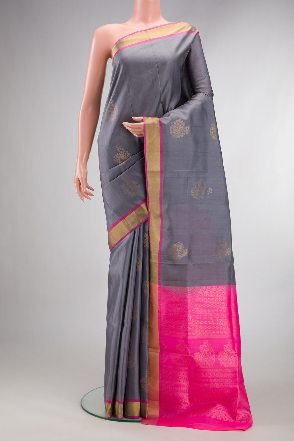 Pure Silk Grey Soft Saree with Zari Butta on the body and Zari Border.  displayed on a mannequin