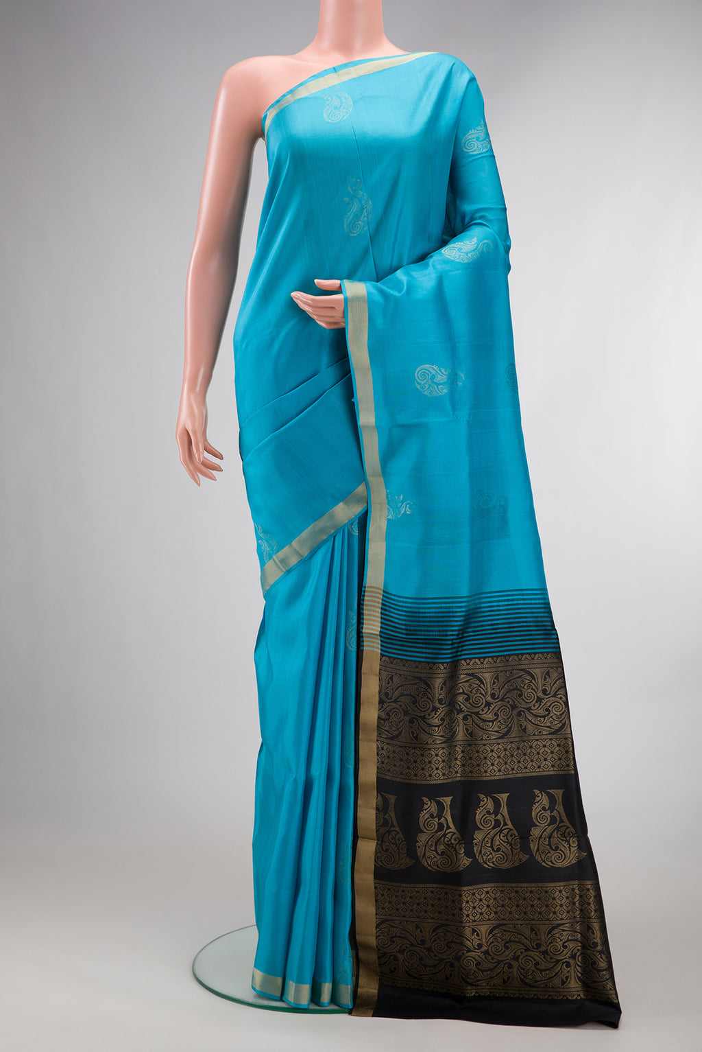 Pure Silk Sky Blue Soft Saree with Zari Butta on the body and Zari Border.  displayed on a mannequin