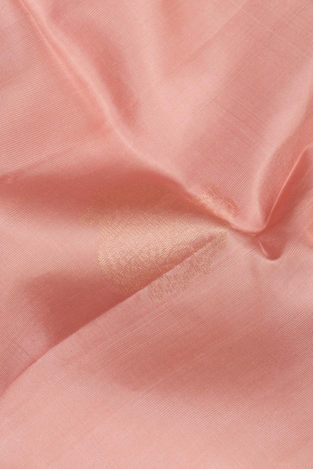 Close up of Pure Silk Golden Peach Soft Saree with Zari Butta on the body and Zari Border.  displaying folds