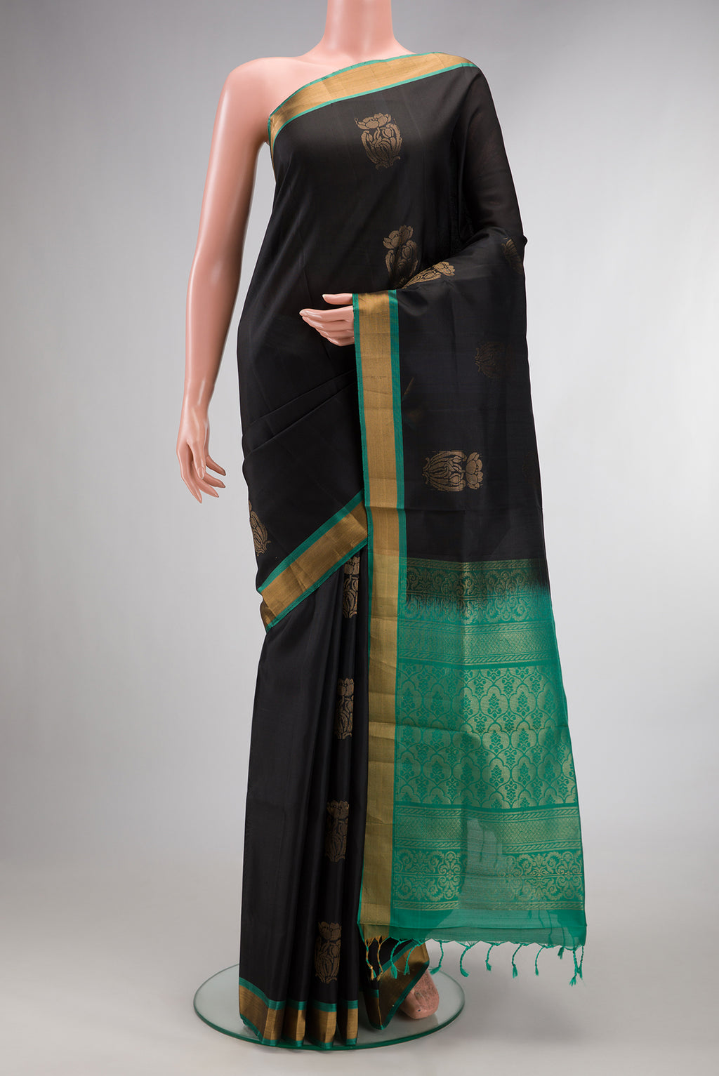 Pure Silk Black Soft Saree with Zari Butta on the body and Zari Border.  displayed on a mannequin