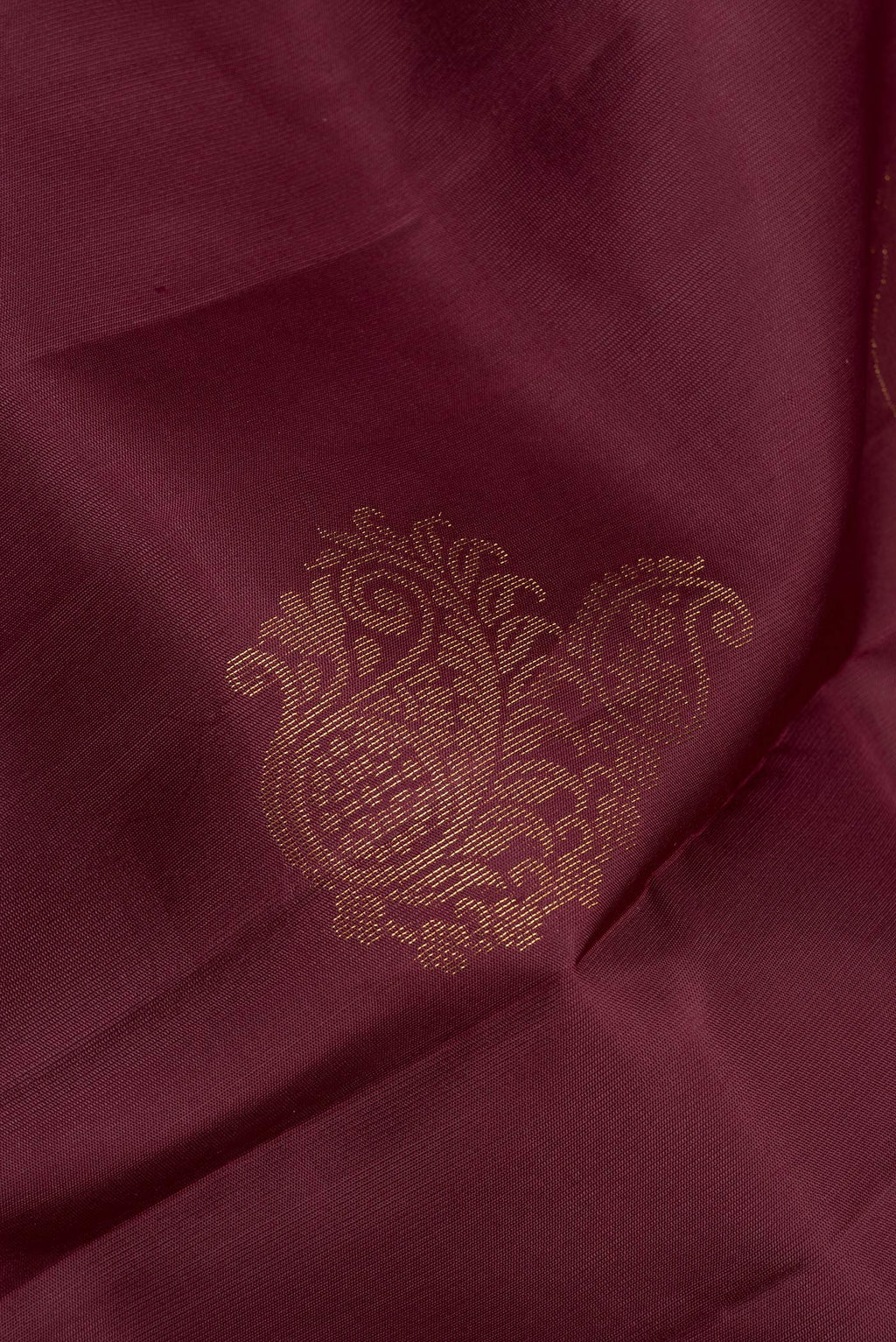 Close up of Pure Silk Brown Soft Saree with Zari Butta on the body and Zari Border.  displaying folds