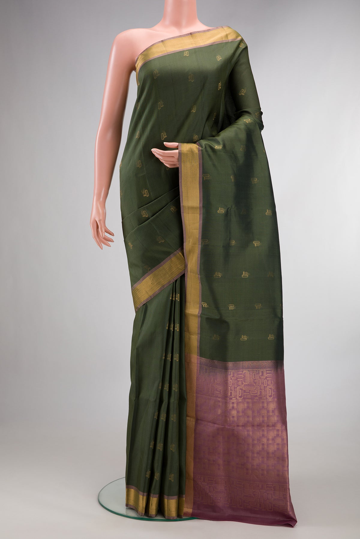 Pure Silk Olive Green Soft Saree with Zari Butta on the body and Zari Border.  displayed on a mannequin
