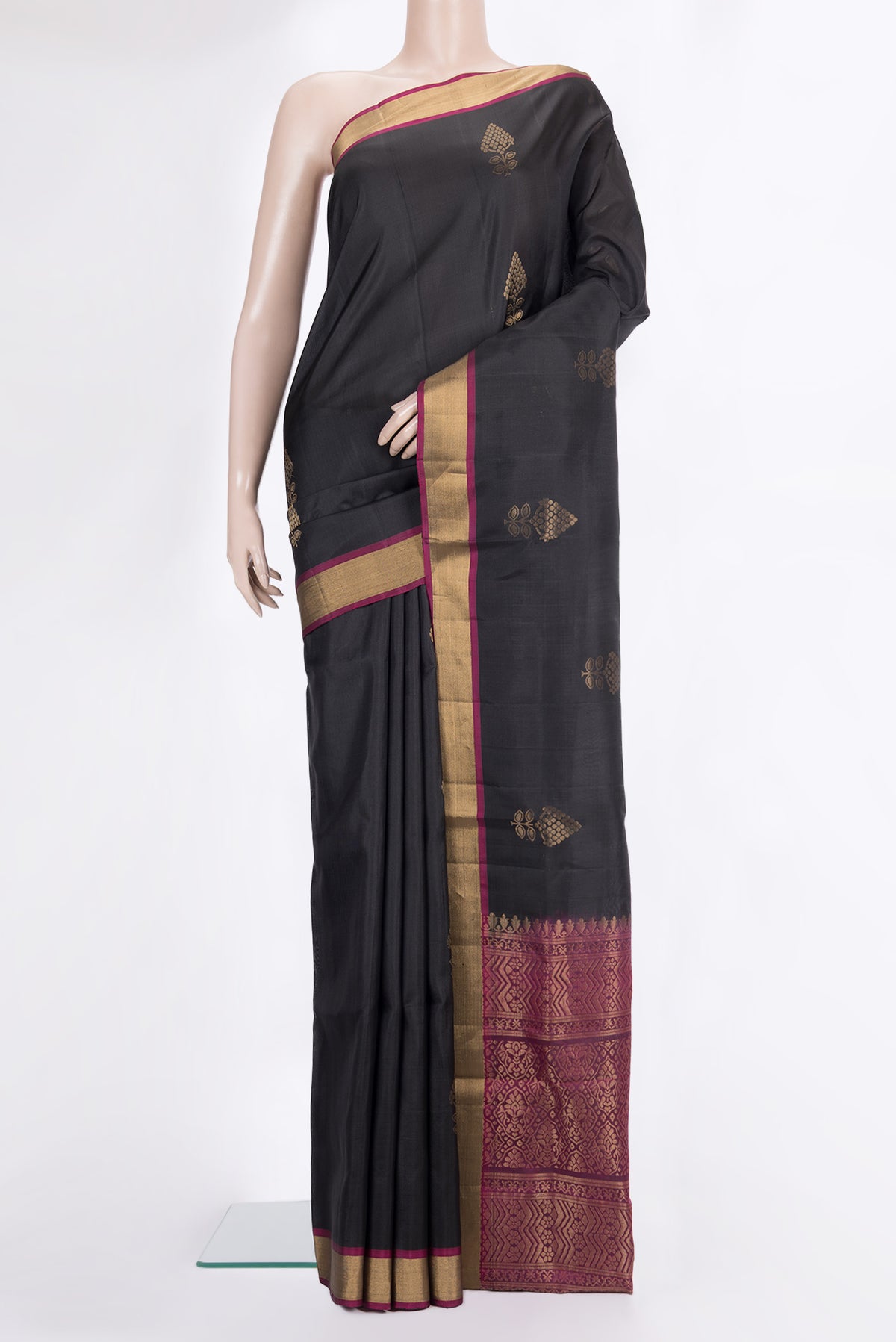 Pure Silk Black Soft Saree with Zari Butta on the body and Zari Border.  displayed on a mannequin