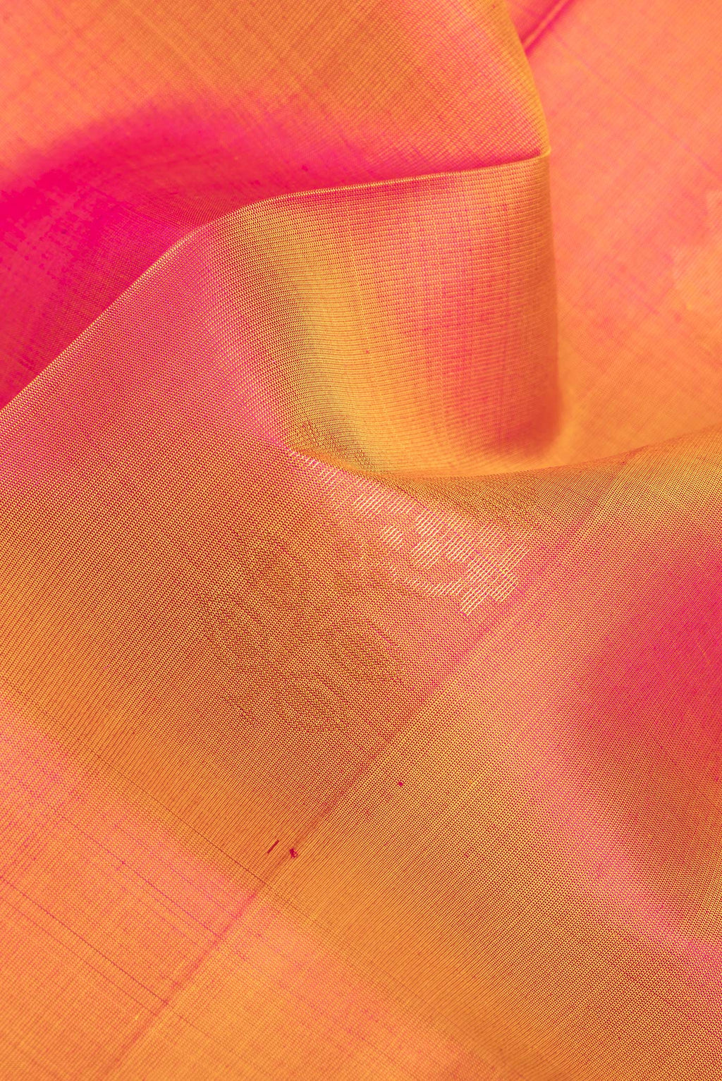 Close up of Pure Silk Pinkish Yellow Dual Tone Soft Saree with Zari Butta on the body and Zari Border.  displaying folds