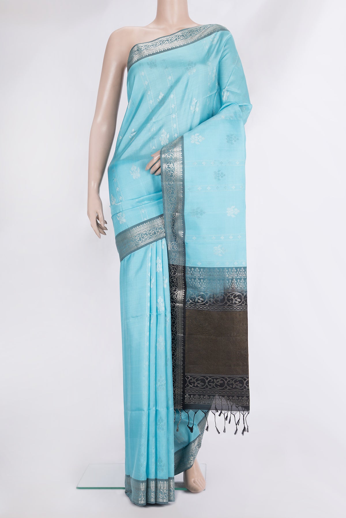 Pure Silk Sky Blue Soft Saree with Zari Butta on the body and Zari Border.  displayed on a mannequin
