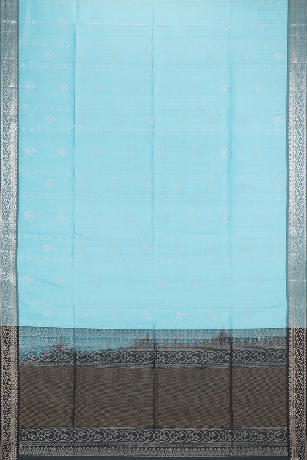 Flat view of Pure Silk Sky Blue Soft Saree with Zari Butta on the body and Zari Border. 