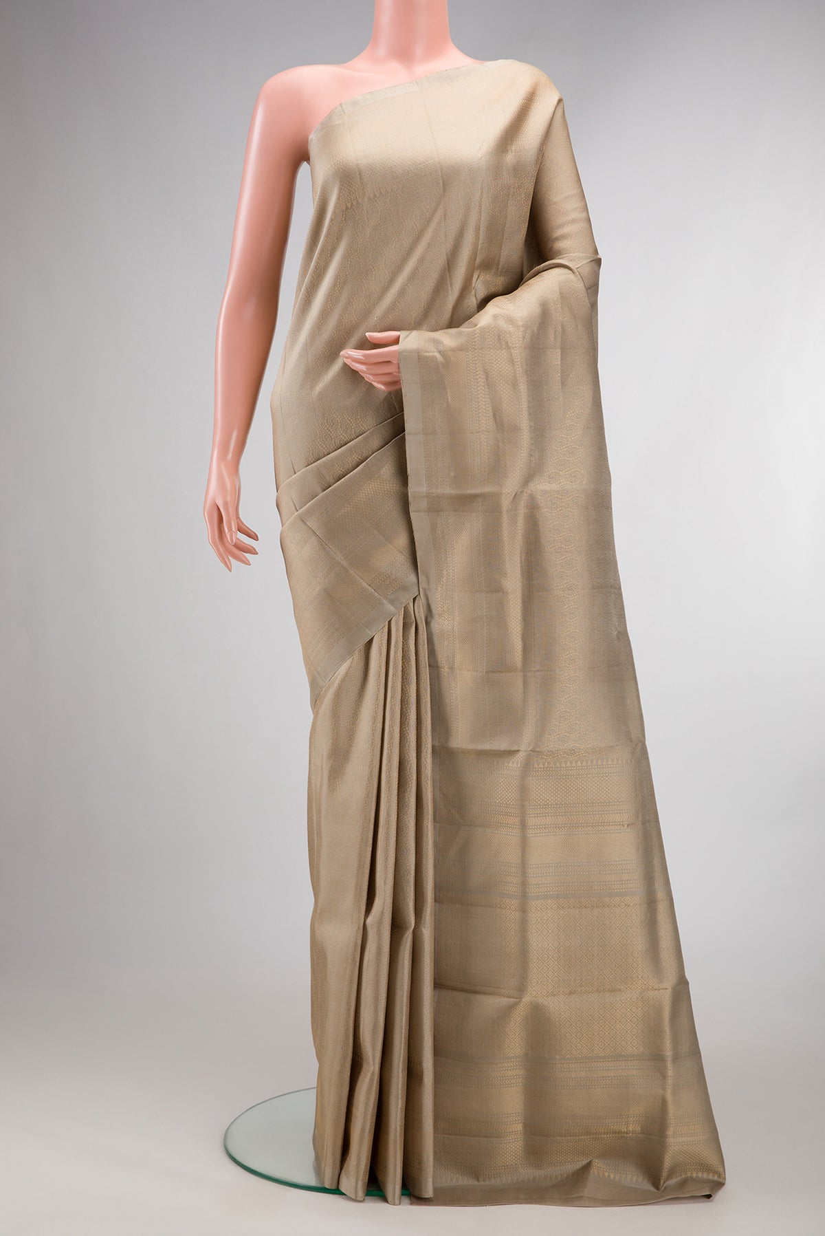 Pure Silk Beige Soft Saree with Zari Brocade on the body and Zari Border.  displayed on a mannequin