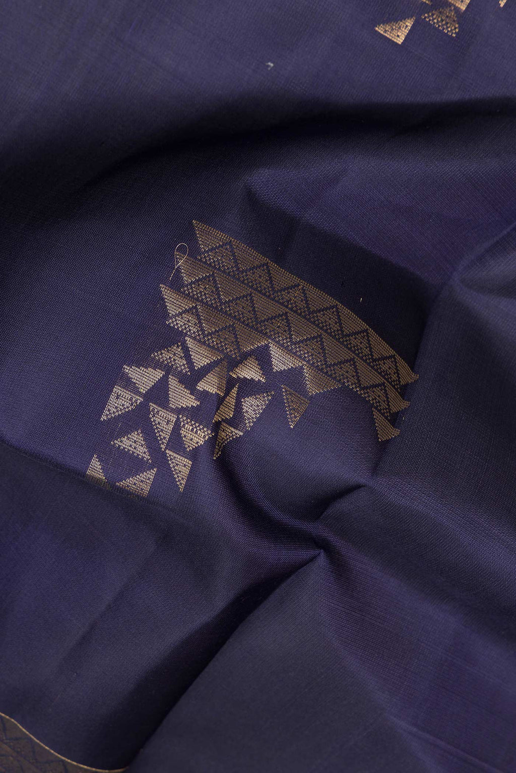 Close up of Pure Silk Navy Blue Soft Saree with Zari Butta on the body and Zari Border.  displaying folds