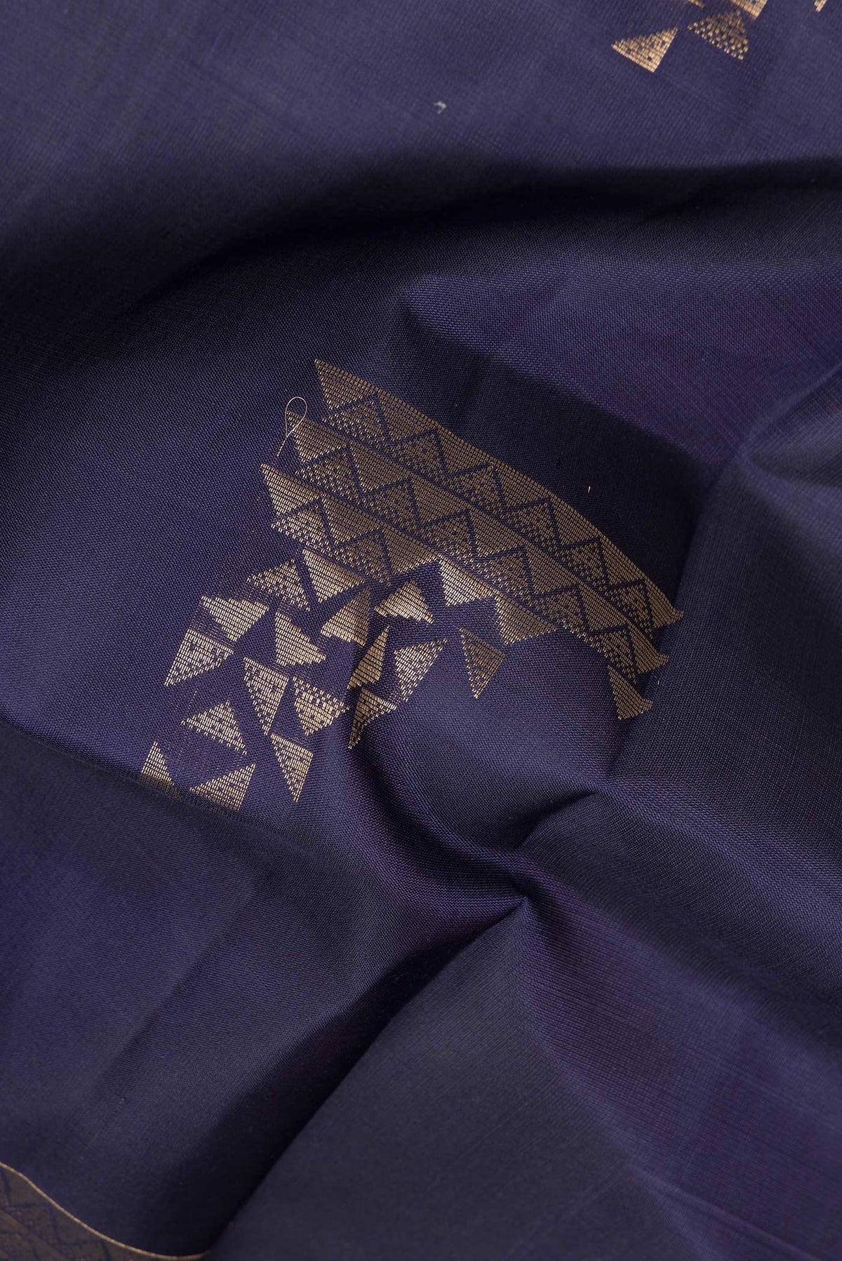 Close up of Pure Silk Navy Blue Soft Saree with Zari Butta on the body and Zari Border.  displaying folds