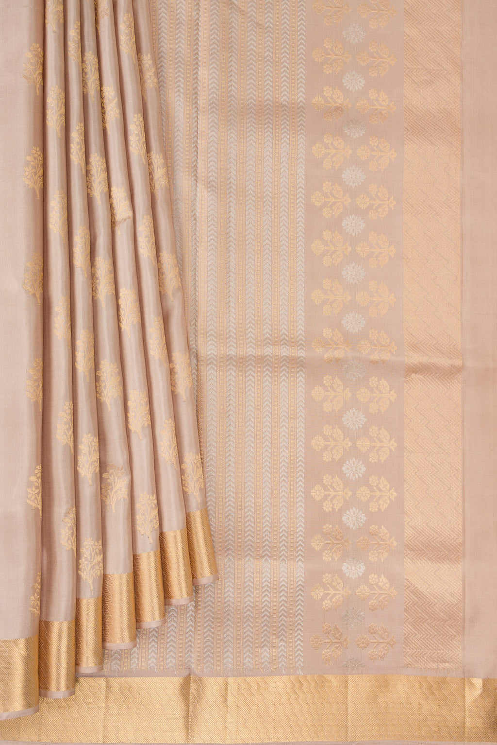 Pleats and pallu of Pure Silk Beige Soft Saree with Zari Butta on the body and Zari Border. 