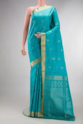 Pure Silk Turquoise Soft Saree with Zari Butta on the body and Zari Border.  displayed on a mannequin