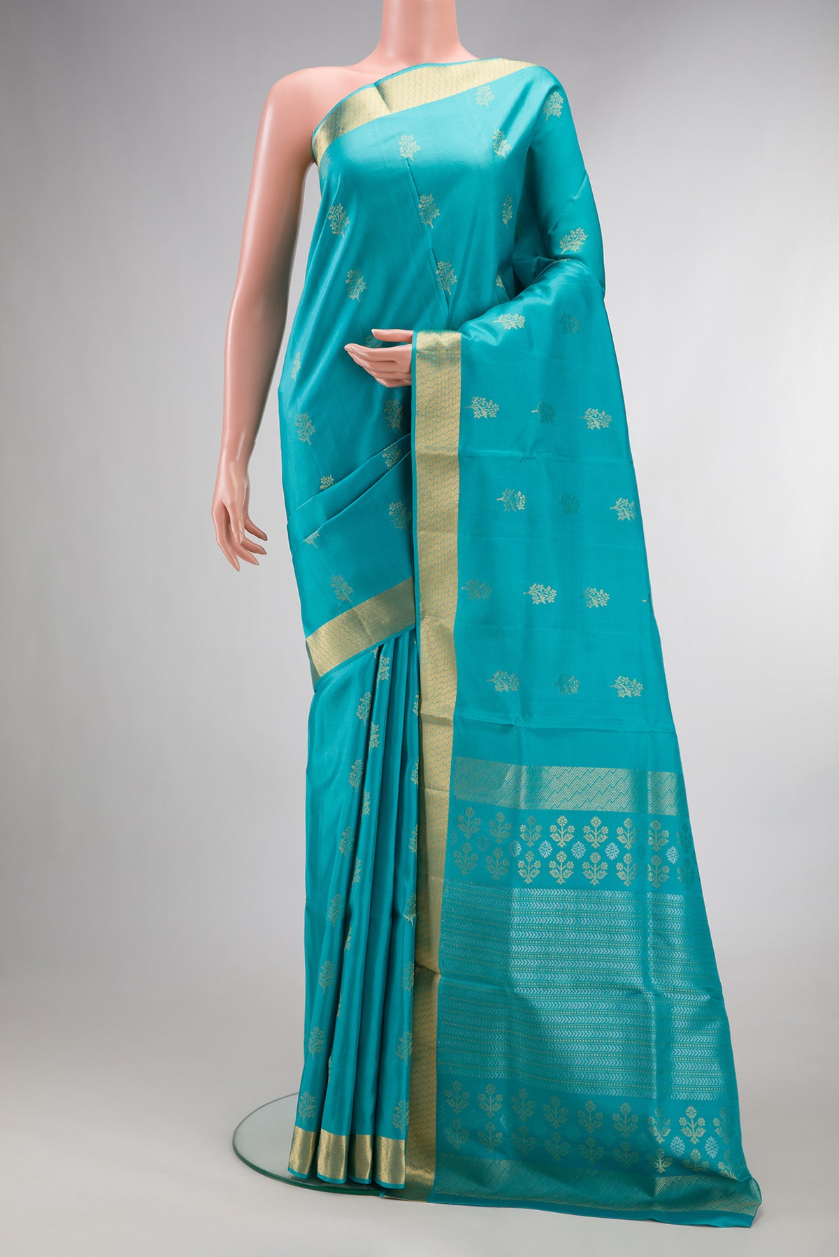 Pure Silk Turquoise Soft Saree with Zari Butta on the body and Zari Border.  displayed on a mannequin