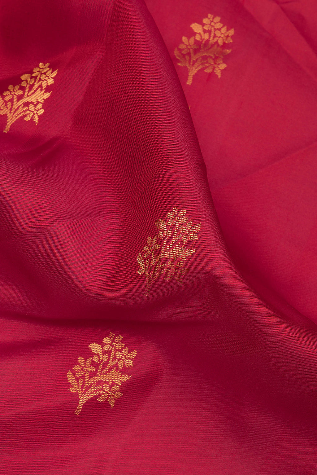 Close up of Pure Silk Red Soft Saree with Zari Butta on the body and Zari Border.  displaying folds