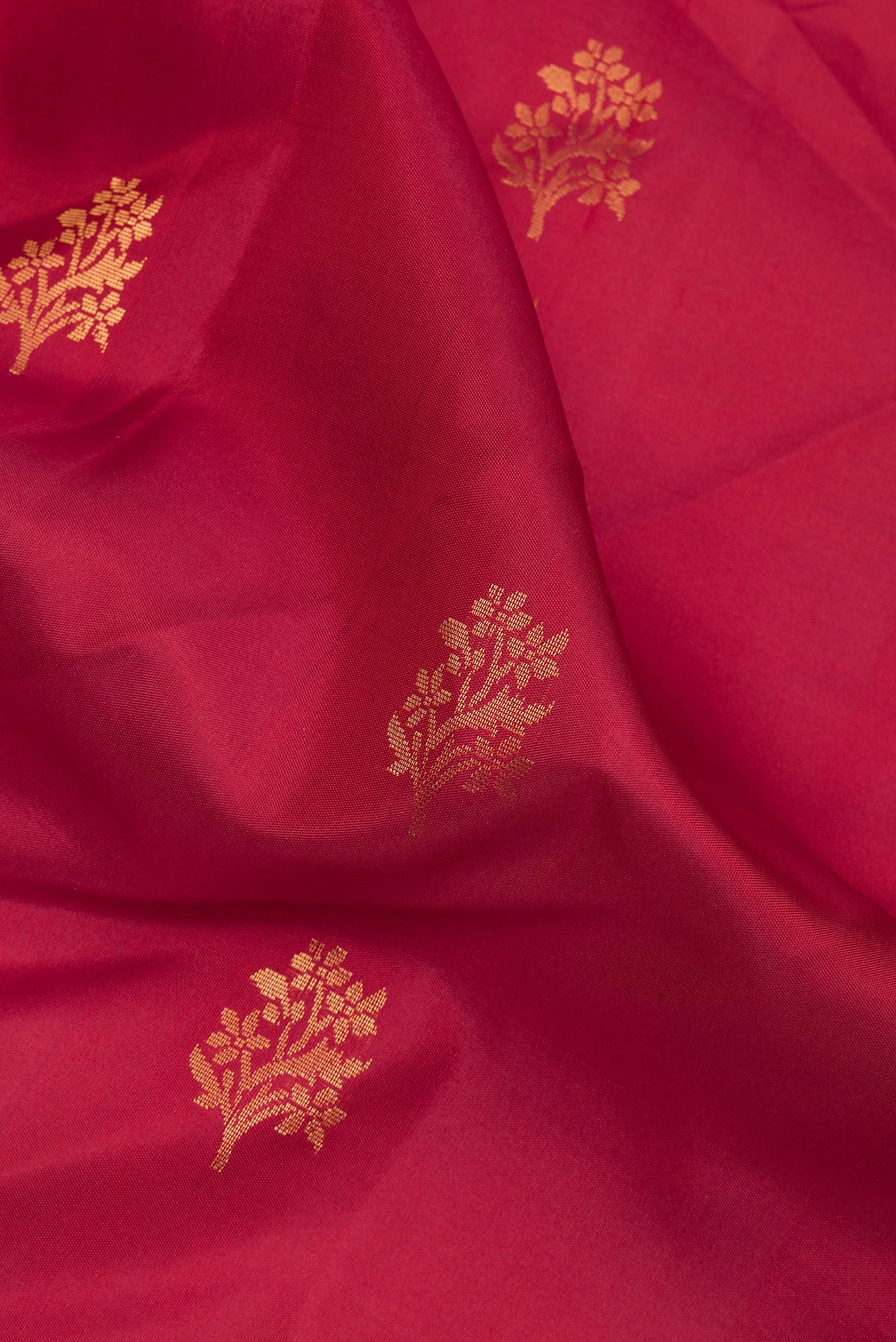 Close up of Pure Silk Red Soft Saree with Zari Butta on the body and Zari Border.  displaying folds