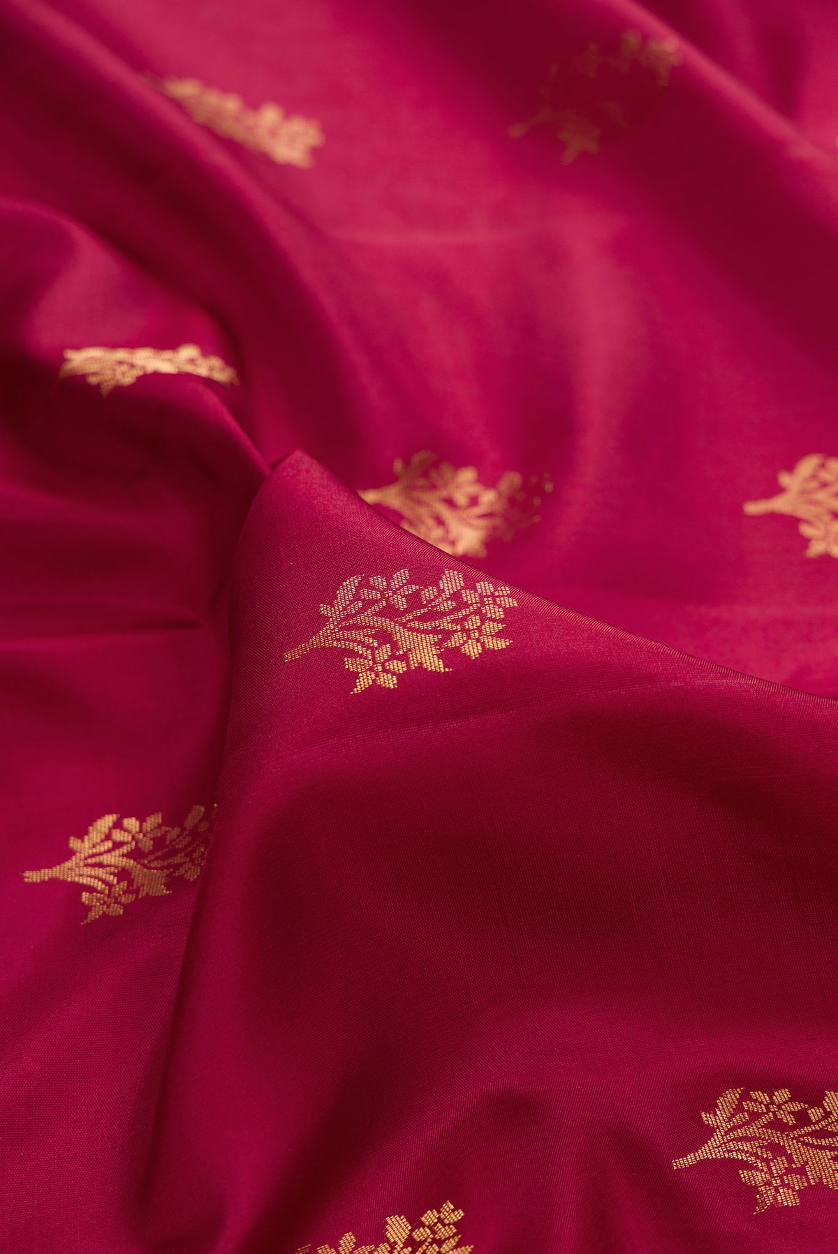 Close up of Pure Silk Maroon Soft Saree with Zari Butta on the body and Zari Border.  displaying folds