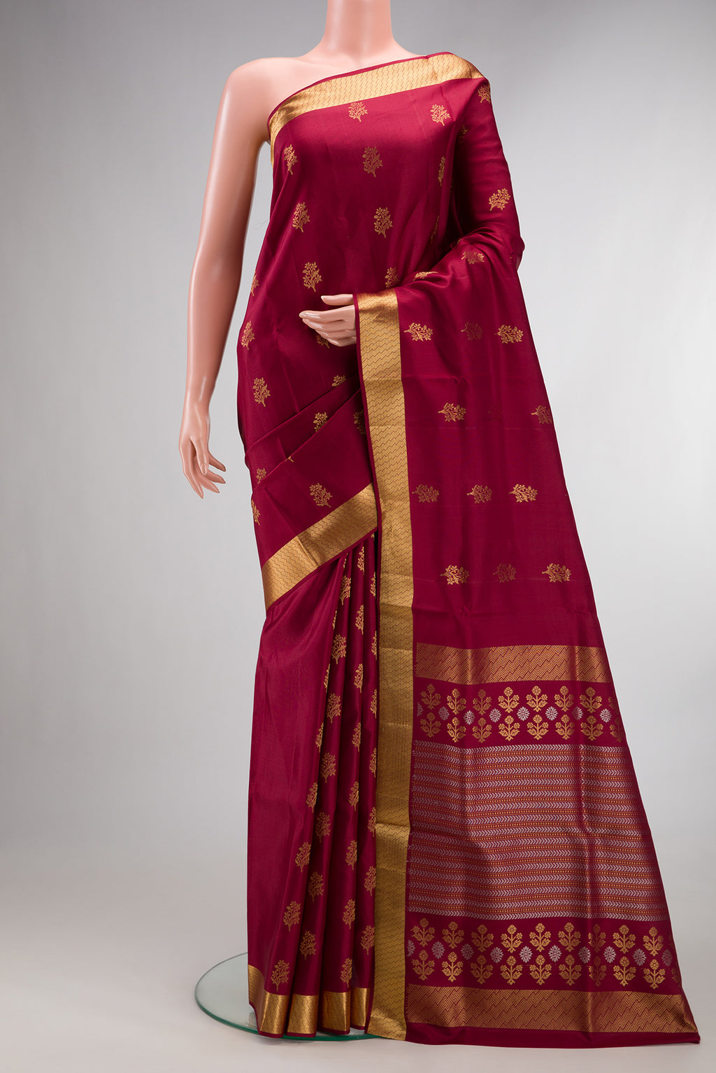 Pure Silk Maroon Soft Saree with Zari Butta on the body and Zari Border.  displayed on a mannequin