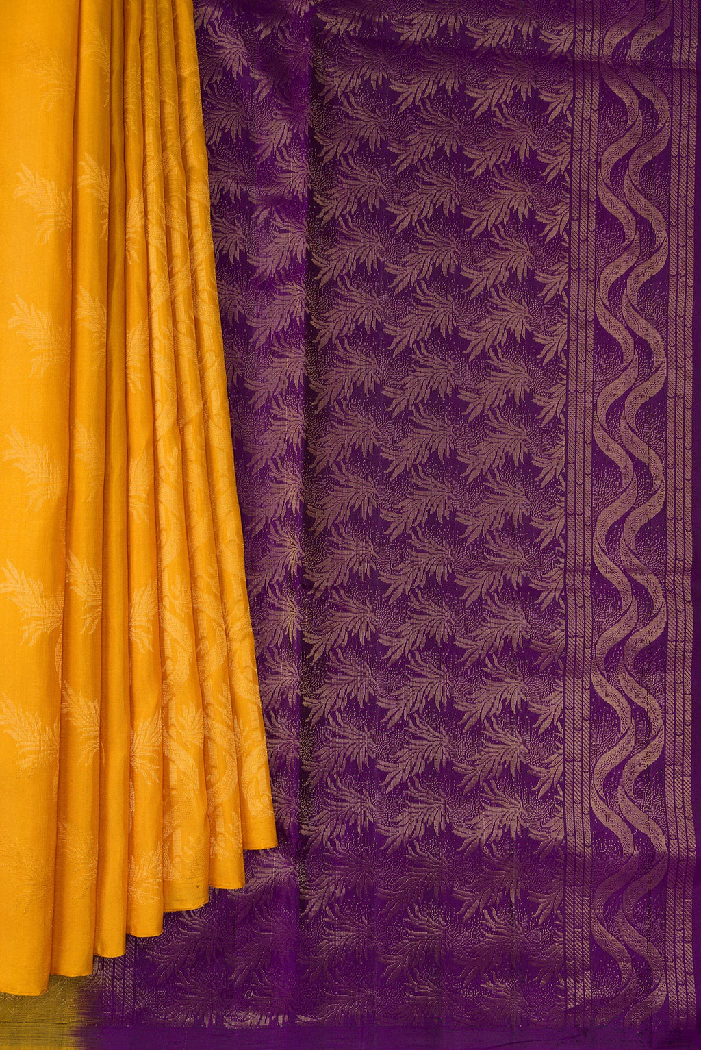 Pleats and pallu of Pure Silk Mustard Soft Saree with Zari Butta on the body and Without Border. 