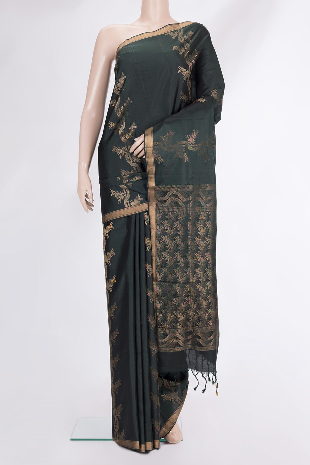 Pure Silk Bottle Green Soft Saree with Zari Butta on the body and Zari Border.  displayed on a mannequin