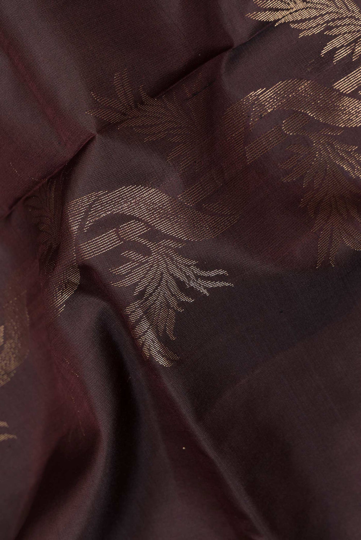 Close up of Pure Silk Coffee Brown Soft Saree with Zari Butta on the body and Zari Border.  displaying folds