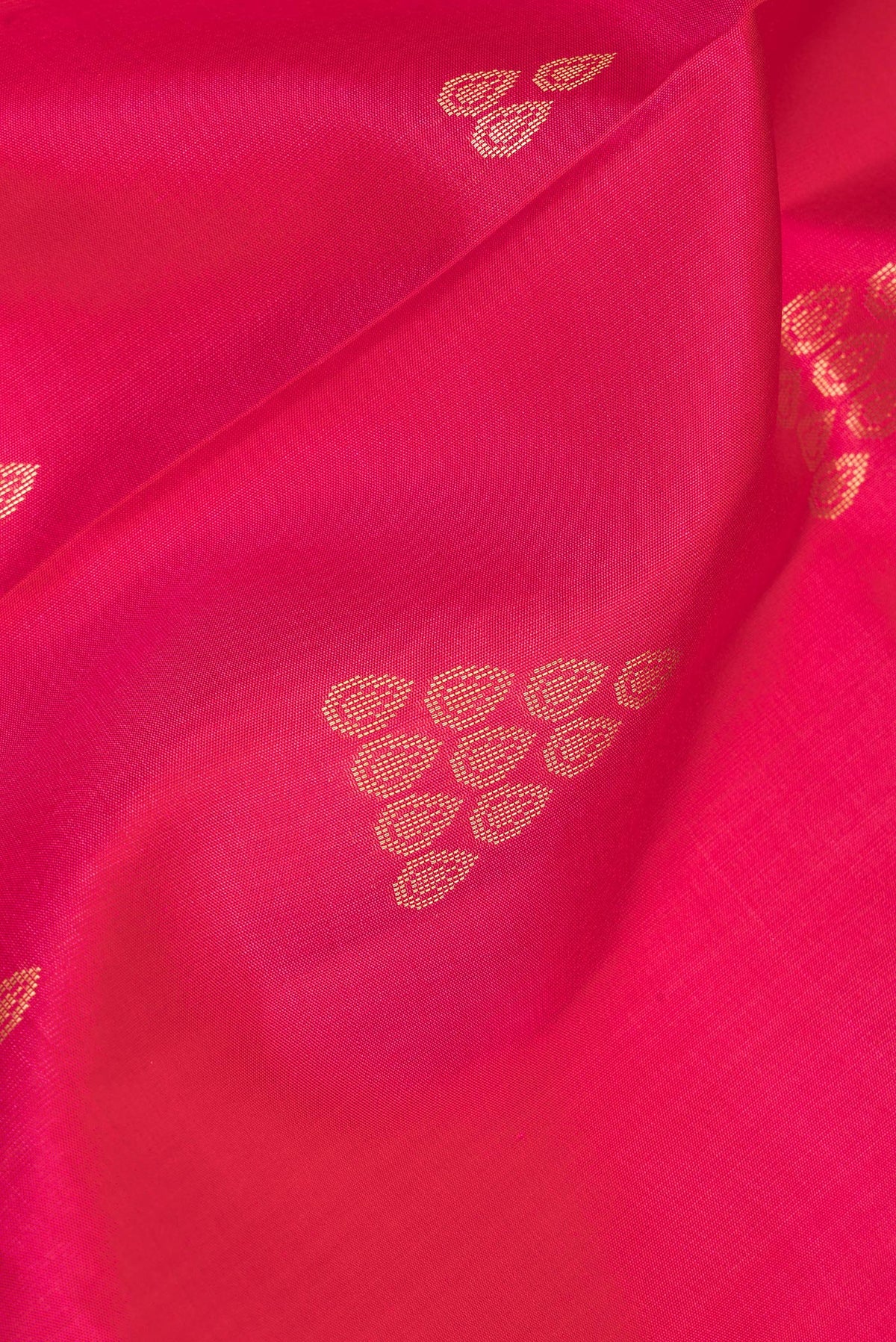Close up of Pure Silk Dark Pink Soft Saree with Zari Butta on the body and Zari Border.  displaying folds