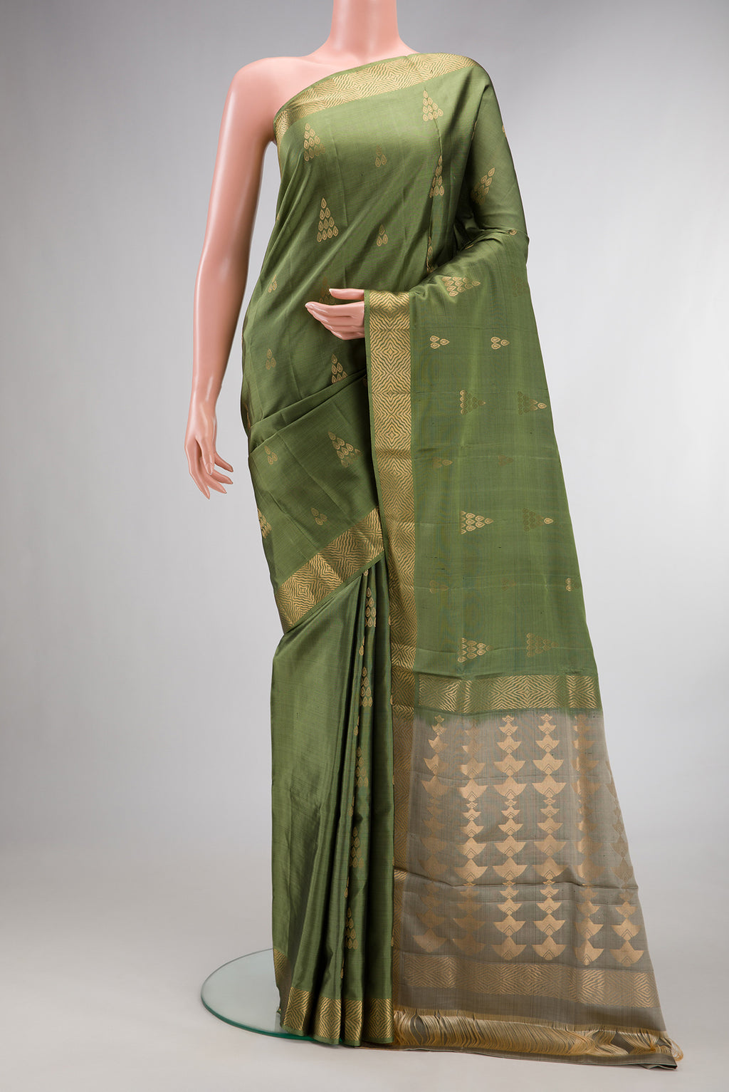 Pure Silk Olive Green Soft Saree with Zari Butta on the body and Zari Border.  displayed on a mannequin