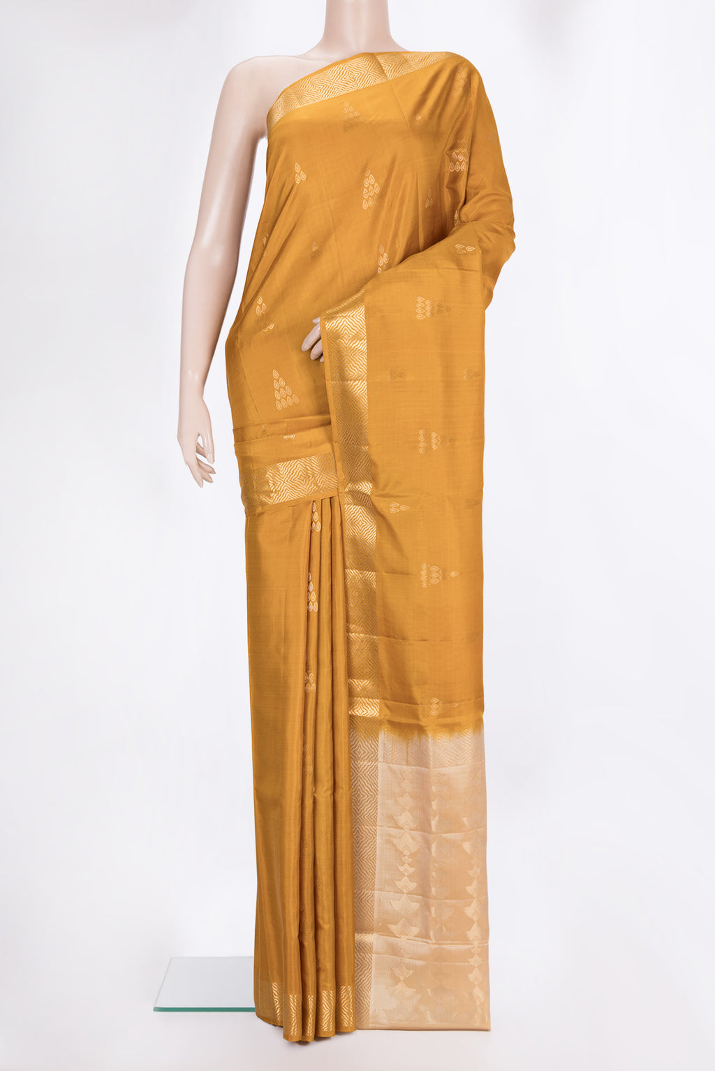 Pure Silk Mustard Soft Saree with Zari Butta on the body and Zari Border.  displayed on a mannequin