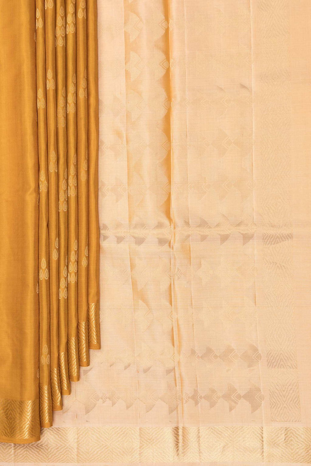 Pleats and pallu of Pure Silk Mustard Soft Saree with Zari Butta on the body and Zari Border. 