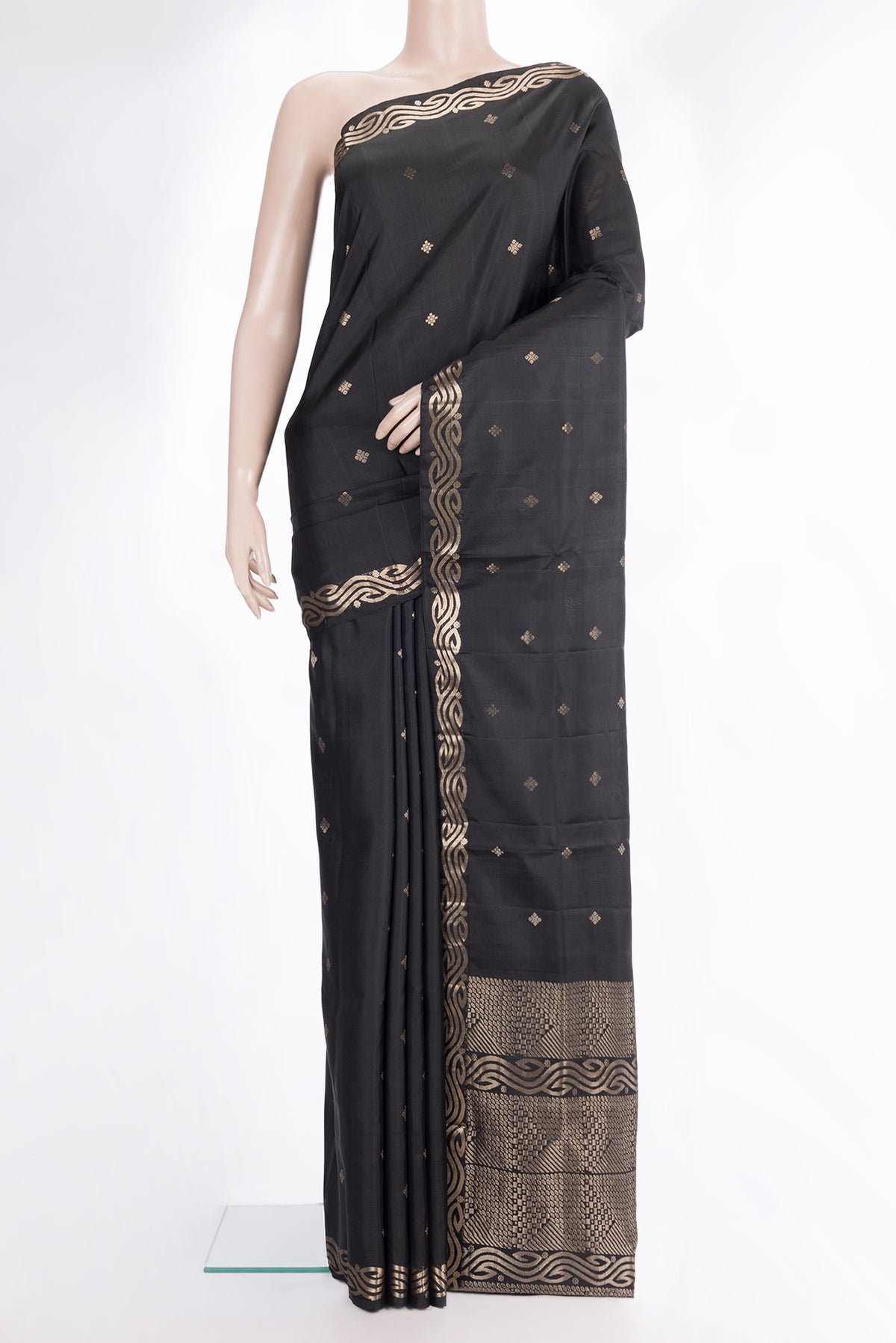 Pure Silk Black Soft Saree with Zari Butta on the body and Zari Border.  displayed on a mannequin