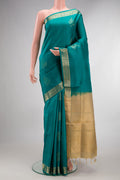 Pure Silk Teal Soft Saree with Zari Butta on the body and Zari Border.  displayed on a mannequin