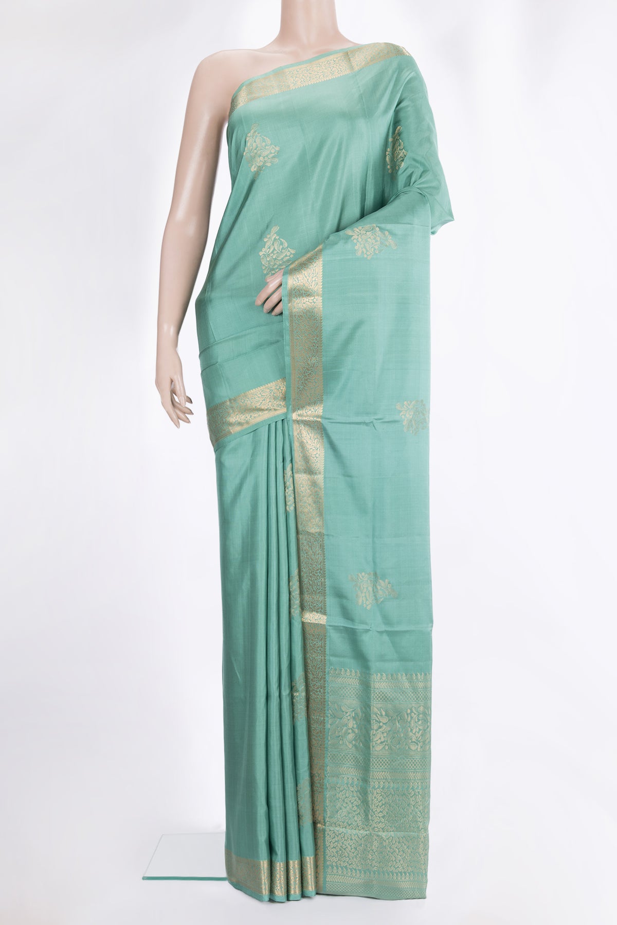 Pure Silk Sea Green Soft Saree with Zari Butta on the body and Zari Border.  displayed on a mannequin