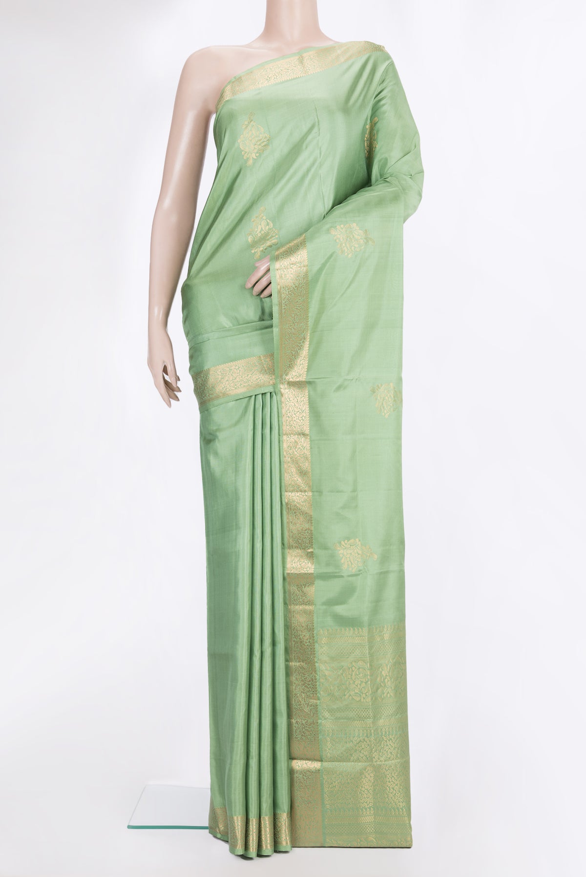 Pure Silk Pista Green Soft Saree with Zari Butta on the body and Zari Border.  displayed on a mannequin
