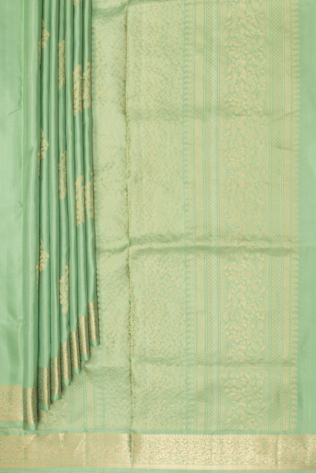 Pleats and pallu of Pure Silk Pista Green Soft Saree with Zari Butta on the body and Zari Border. 