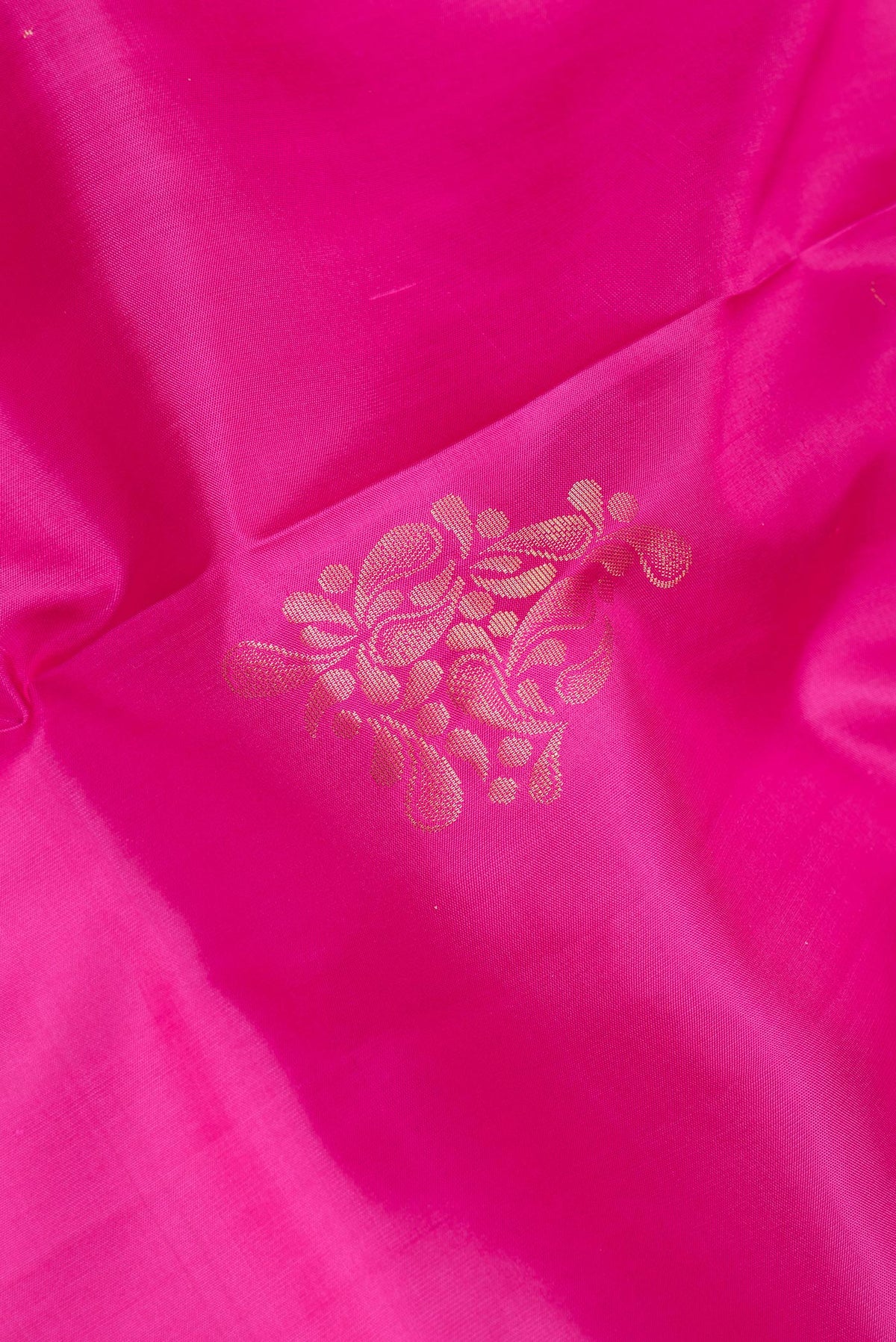 Close up of Pure Silk Pink Soft Saree with Zari Butta on the body and Zari Border.  displaying folds