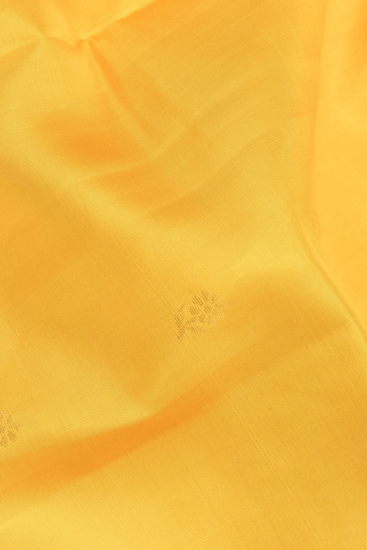 Close up of Pure Silk Yellow Soft Saree with Zari Butta on the body and Zari Border.  displaying folds