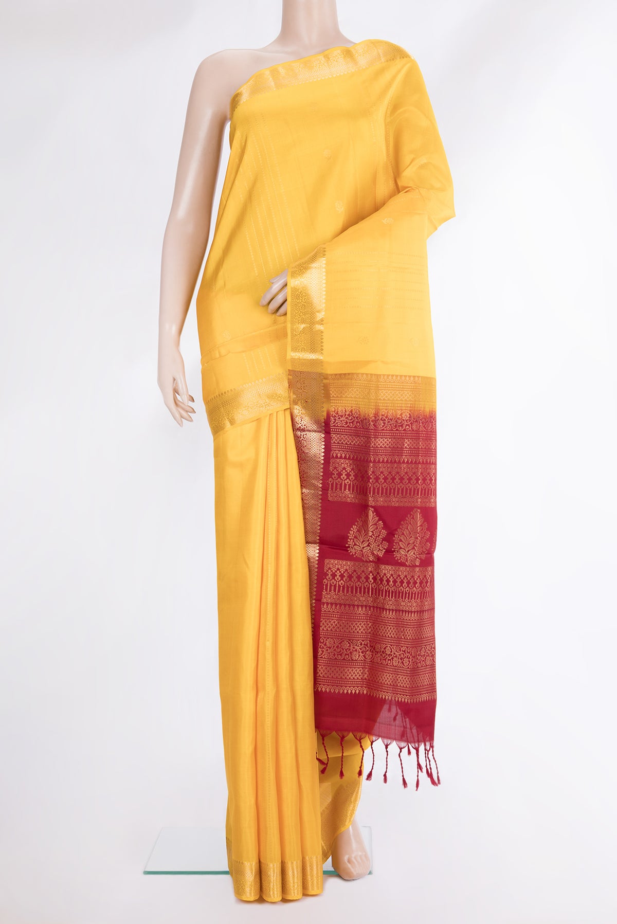 Pure Silk Yellow Soft Saree with Zari Butta on the body and Zari Border.  displayed on a mannequin
