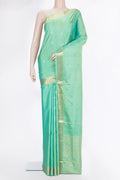 Pure Silk Sea Green Dual Tone Soft Saree with Zari Butta on the body and Zari Border.  displayed on a mannequin