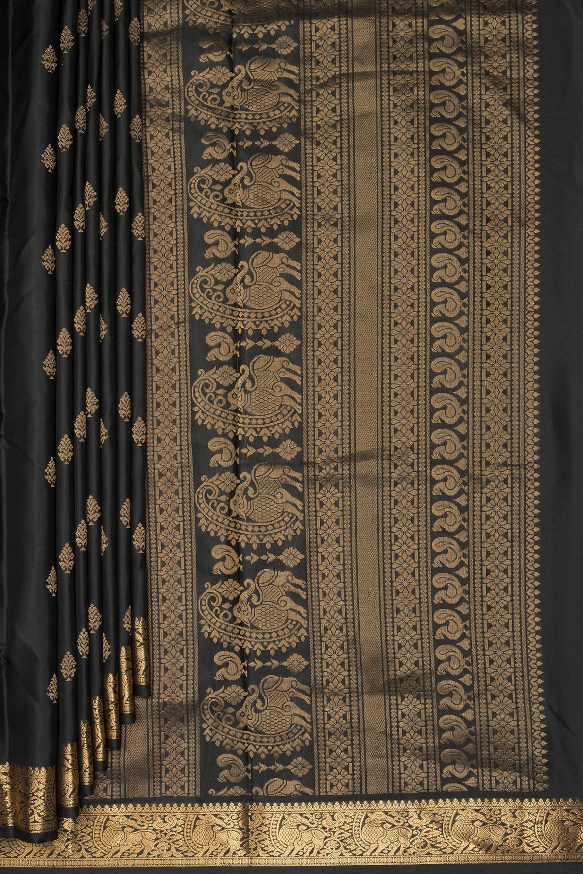 Pleats and pallu of Pure Silk Black Soft Saree with Zari Butta on the body and Zari Border. 