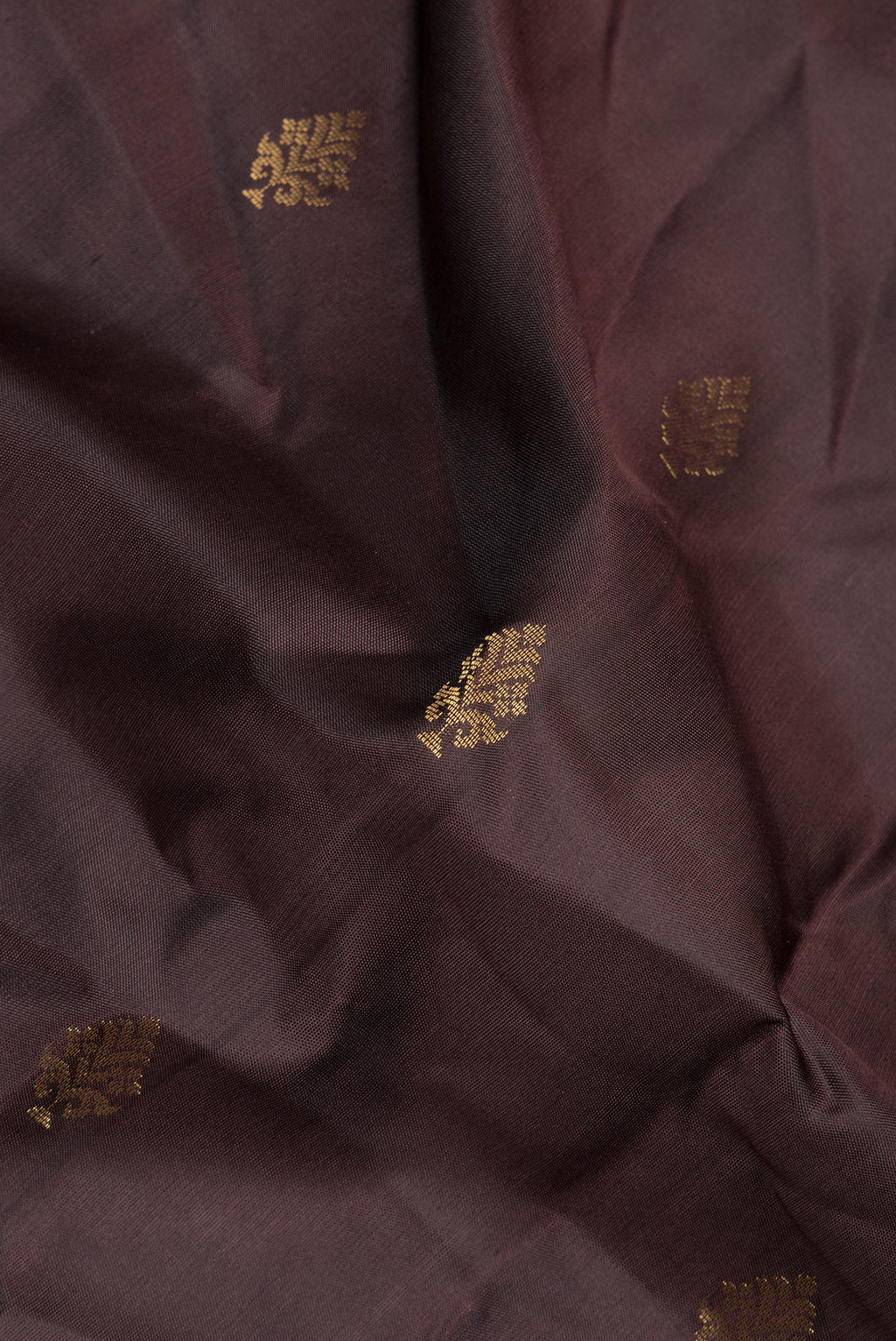 Close up of Pure Silk Coffee Brown Soft Saree with Zari Butta on the body and Zari Border.  displaying folds